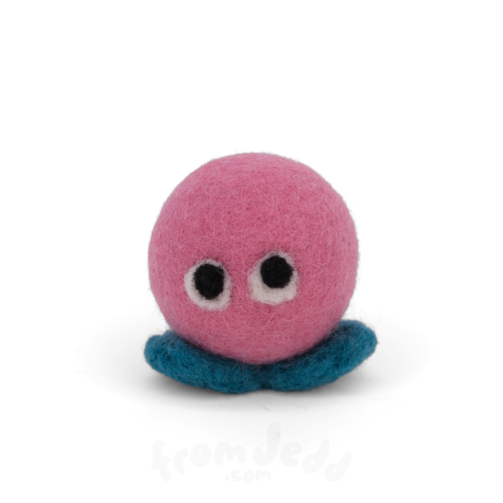 A pink felt creature with two eyes and teal feet.