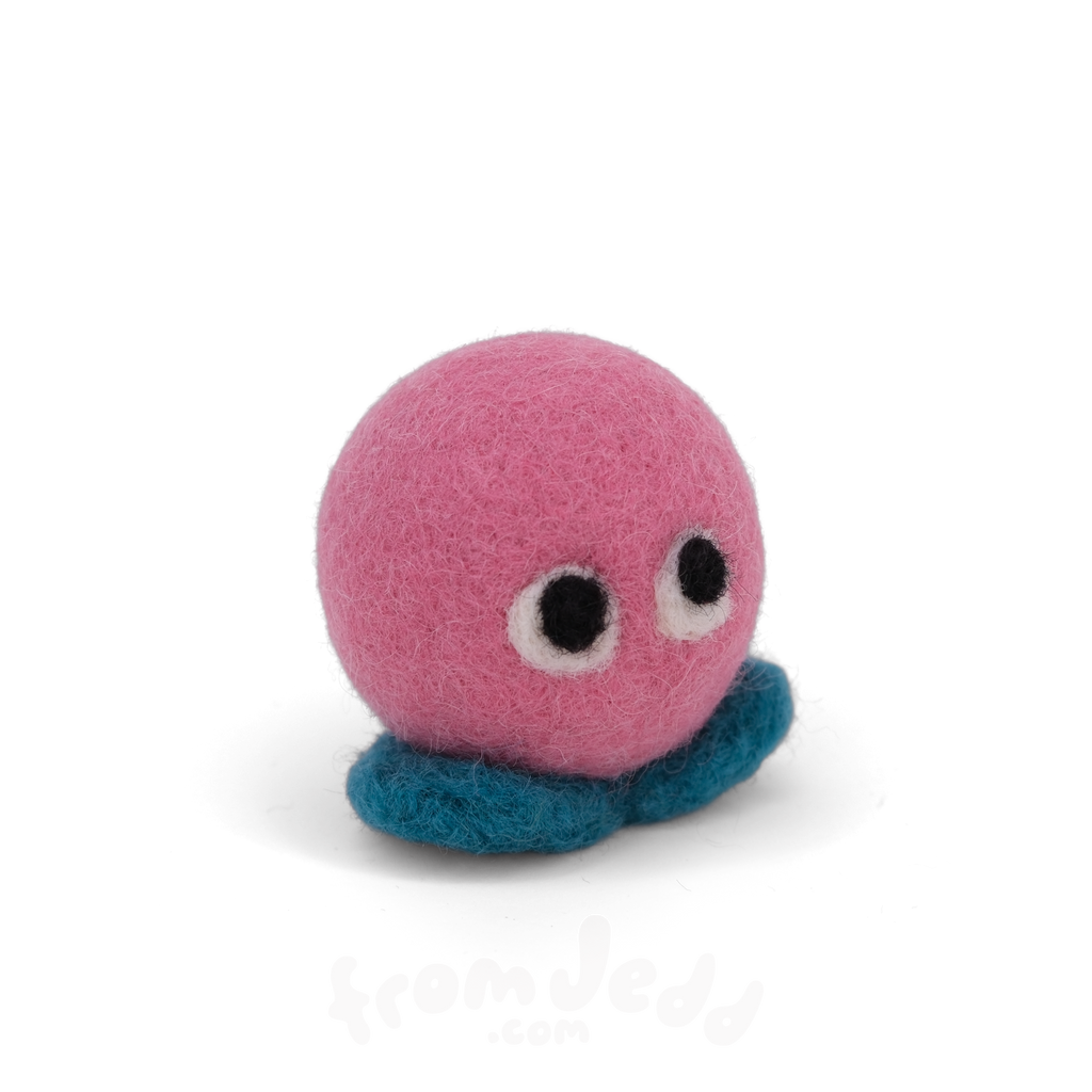 A pink felt creature with two eyes and teal feet.