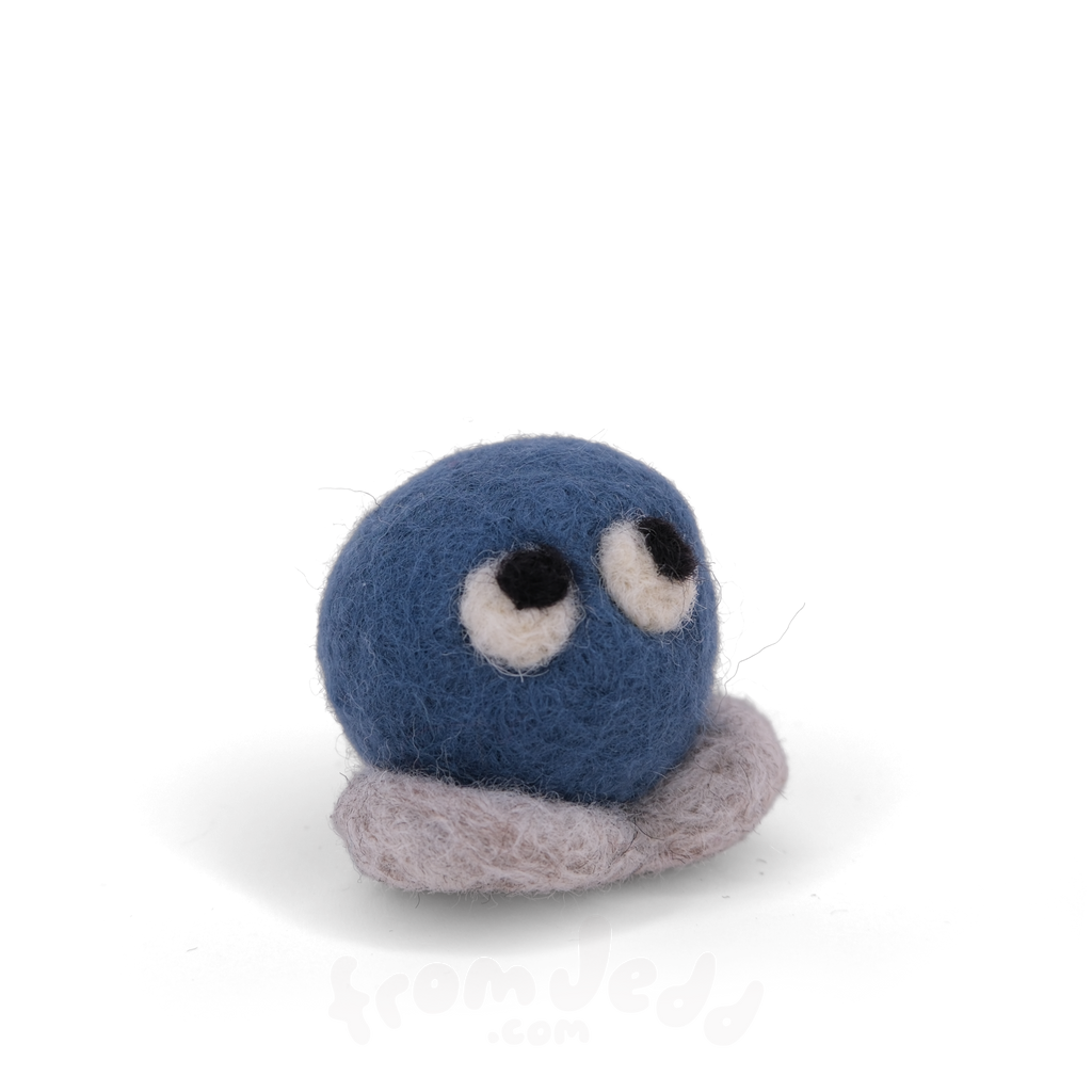 A blue felted creature with eyes looking up and grey feet.