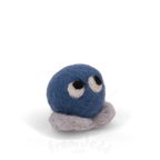 A blue felted creature with eyes looking up and grey feet.