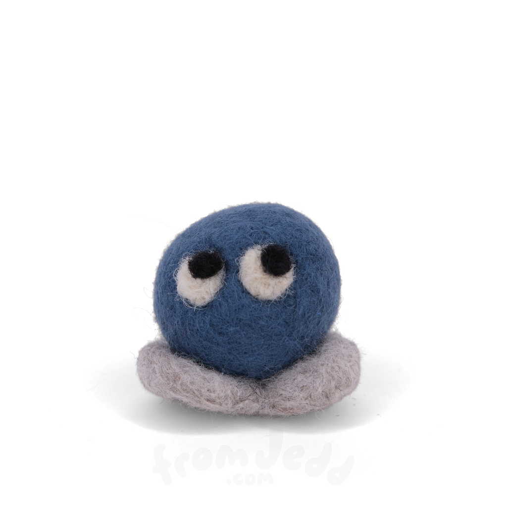 A blue felted creature with eyes looking up and grey feet.