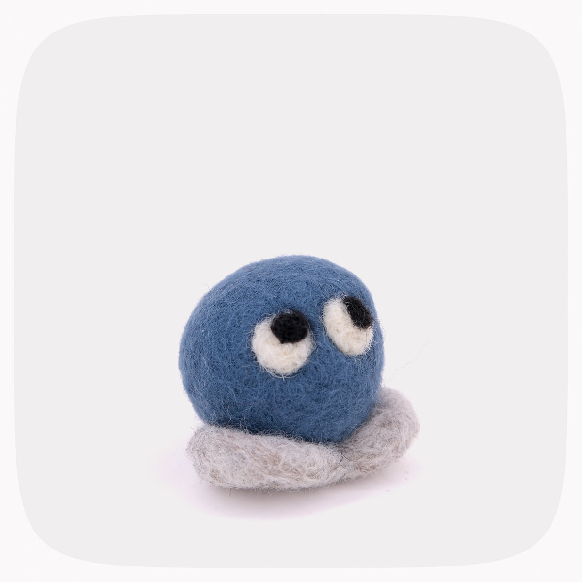 A blue felted circle with eyes and gray feet.