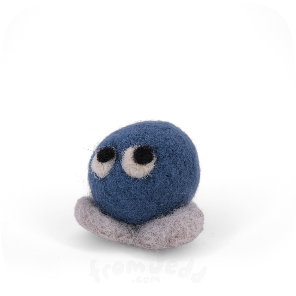 A blue felted creature with eyes looking up and grey feet.