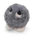 A small gray fuzzy ball character with white feet and large white eyes with black centers, photographed on a clean white background.