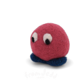 A small red felted creature with big eyes and blue feet